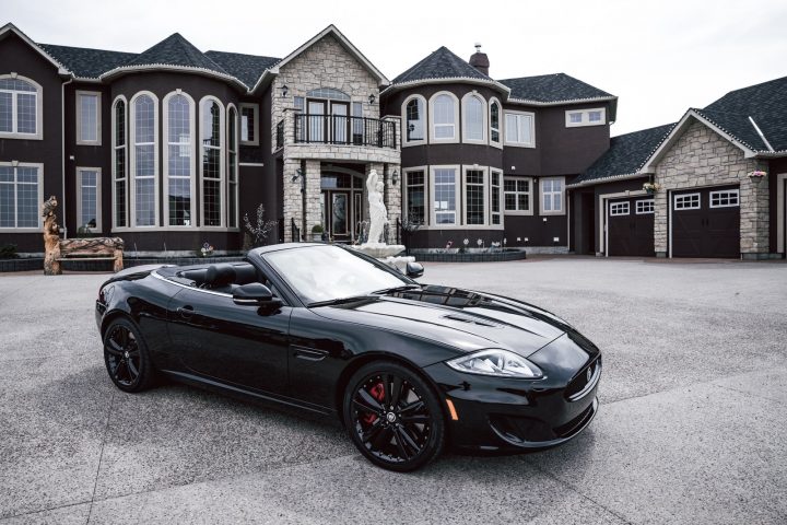 black convertible coupe parked near house